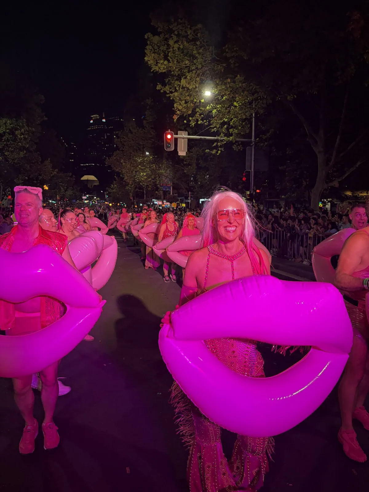 Kirsten leading the Mardi Gras float with pink lip props